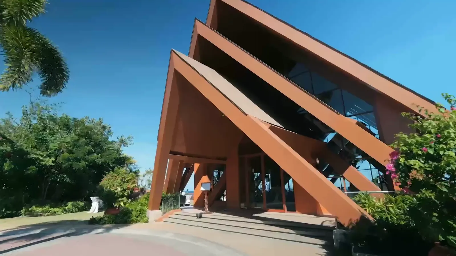 The timber A-frame of the Ocean Pavilion against a clear blue sky