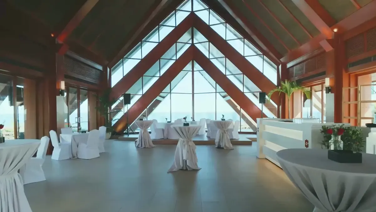 Inside the Ocean Pavilion: tall timber and glass A-frames looking out to sea
