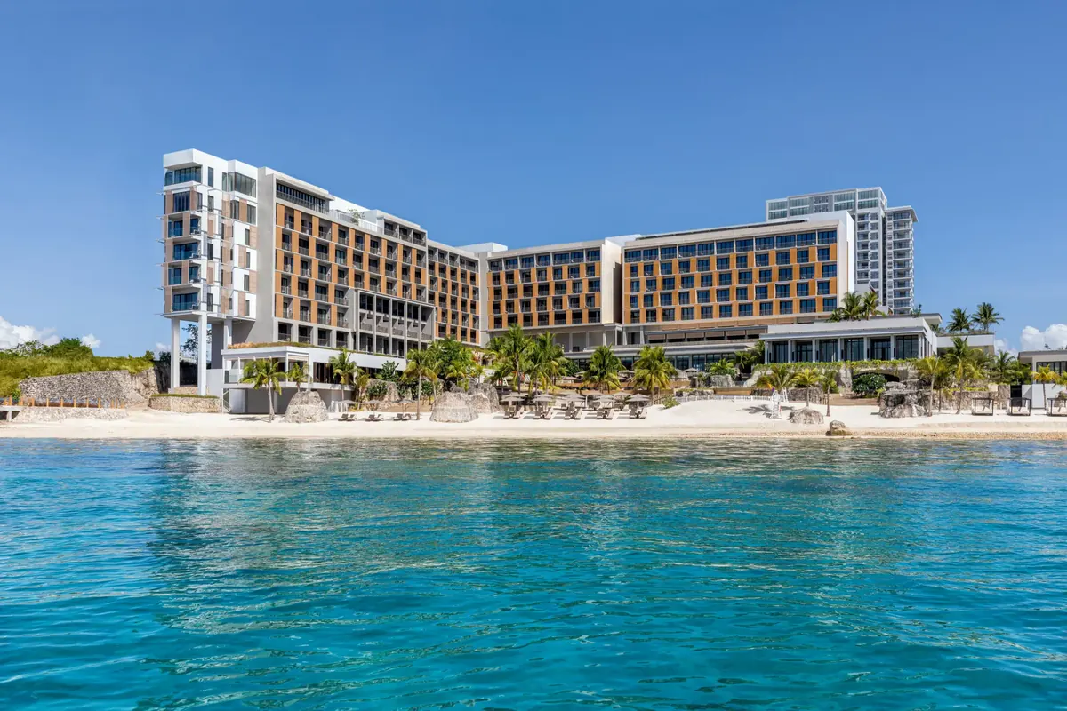 Sheraton Cebu Mactan Resort seen from the water, with its beach and palms